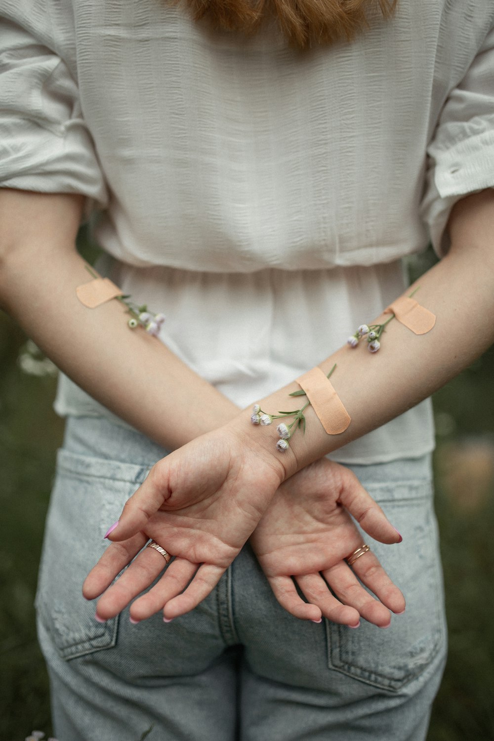 person with her arms crossed on her back