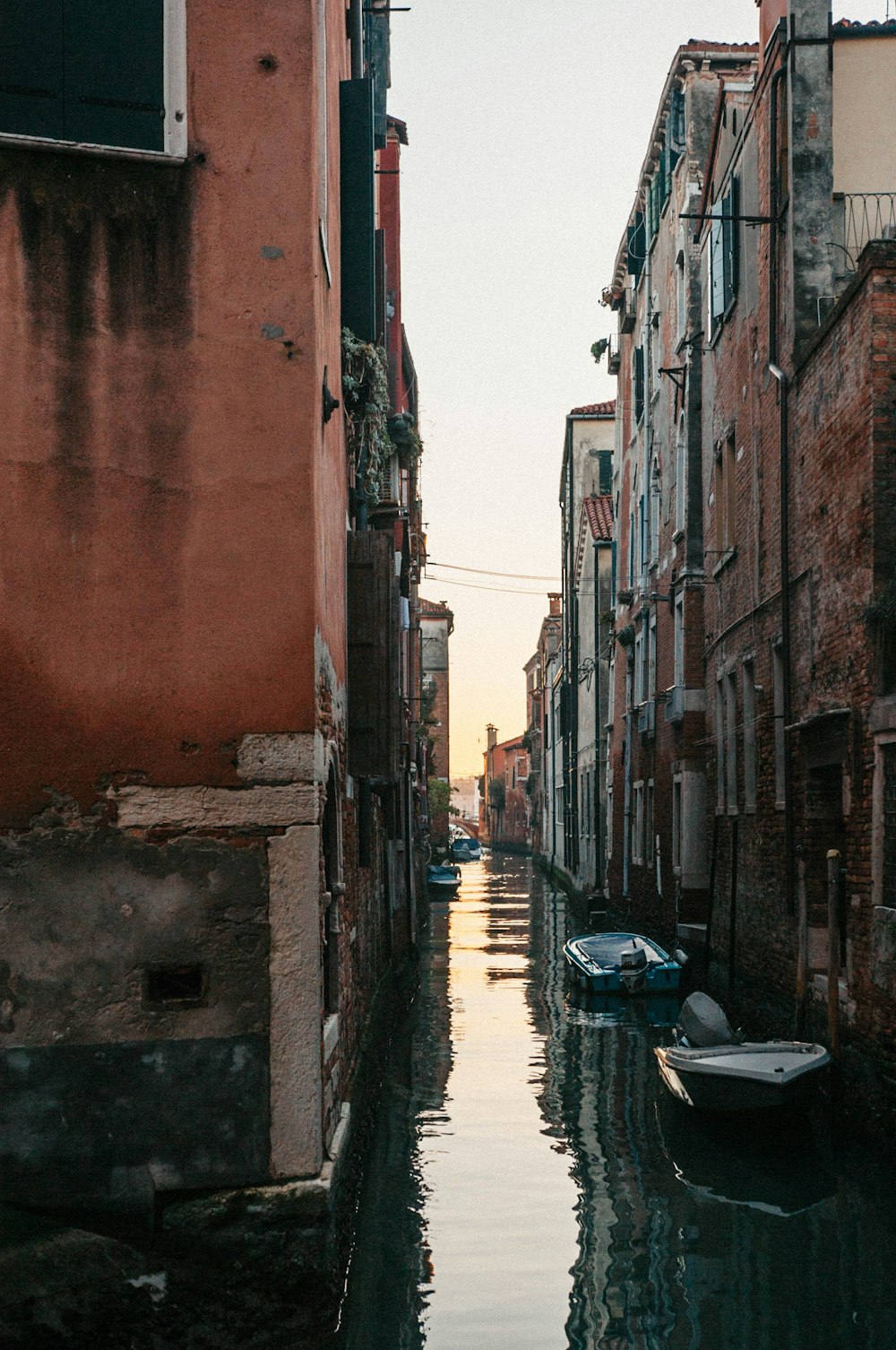 two gray boats near buildings