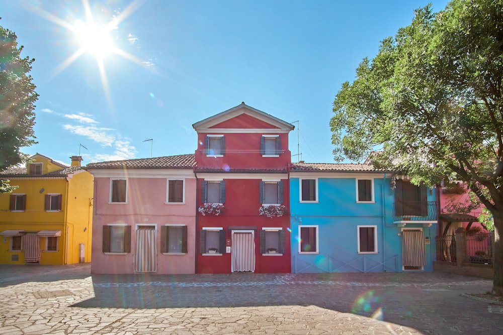 3-storey house beside tree during daytime