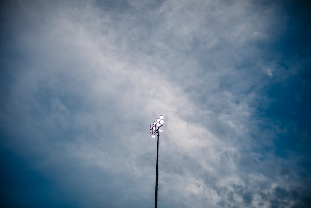 a street light with a cloudy sky in the background