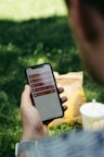 persona viendo iphone con un mcmenu de mcdonalds