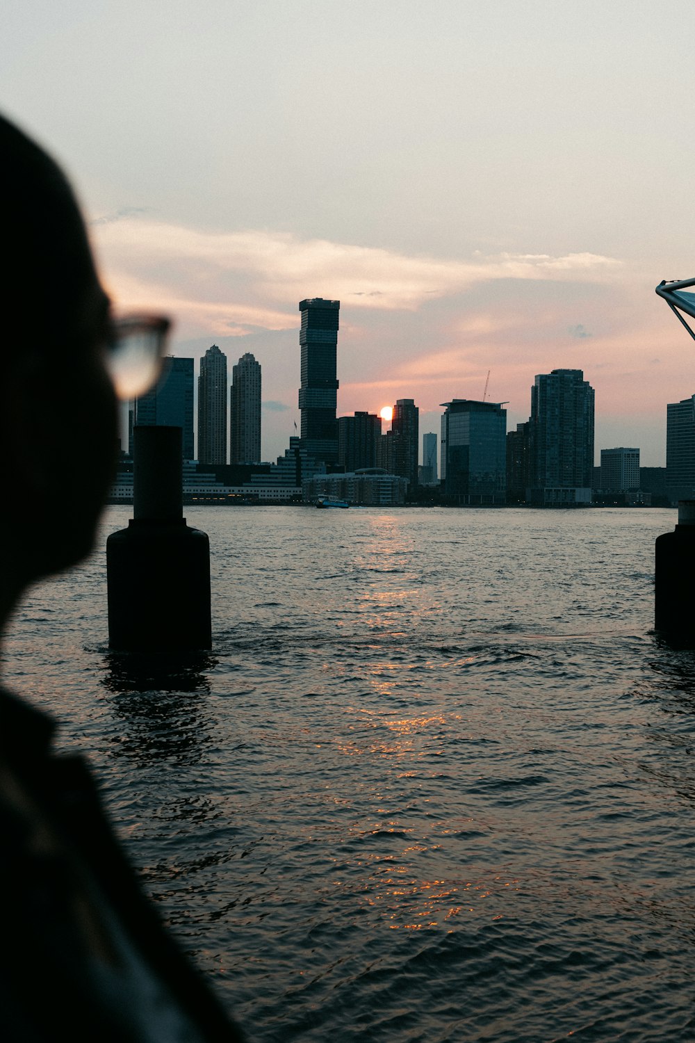 silhouette of woman standing in front of city