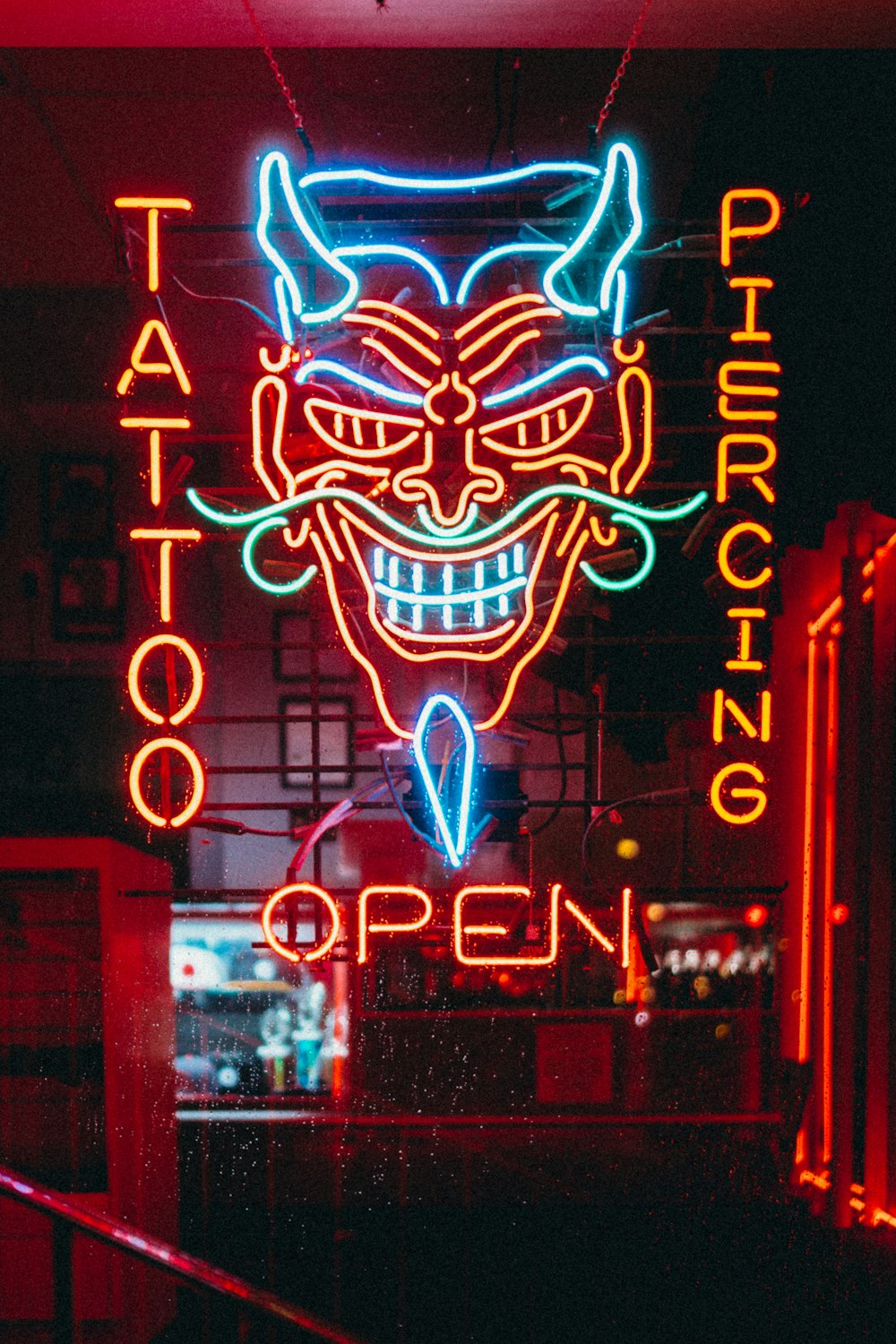 red and blue tattoo piercing open LED sign