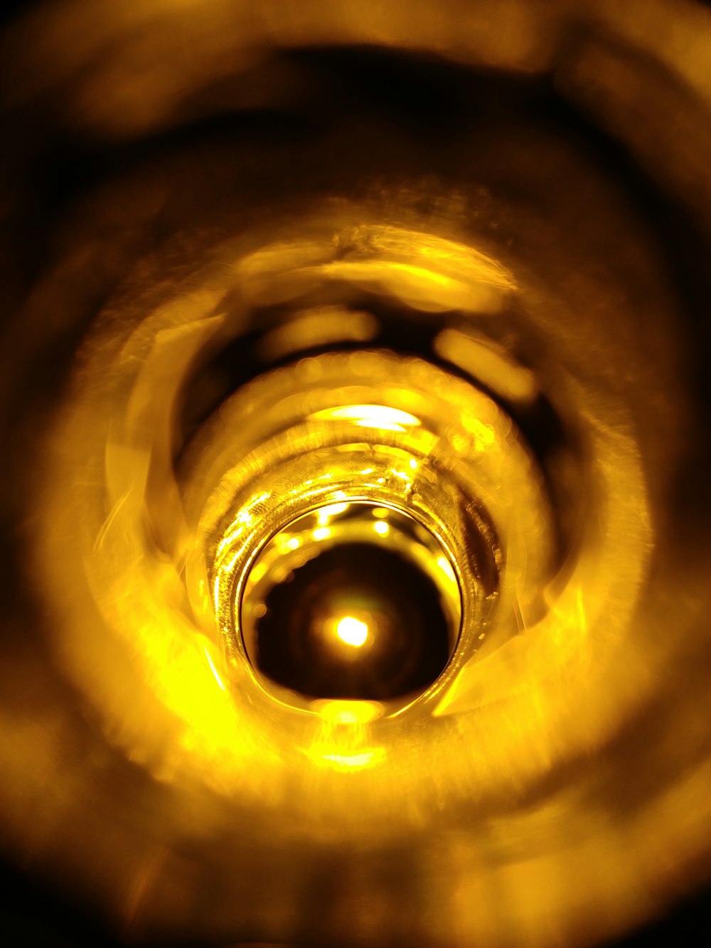 a close up of a yellow light in a dark room