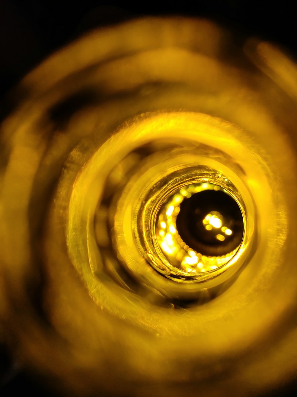 a close up of a yellow object with a black background