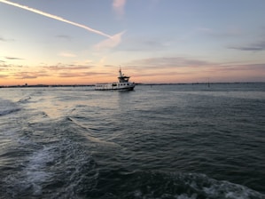 white boat out at sea at dusk