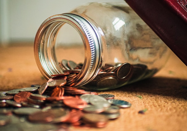 assorted coin lot in clear glass jar