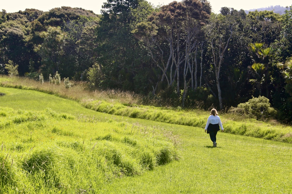 woman standing on field near forest