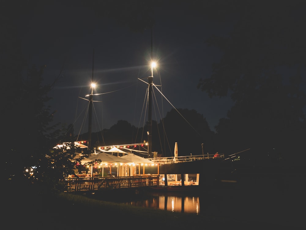 lighted boat masts in dock at night