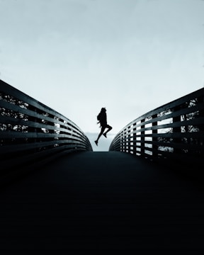 person jumping over the bridge