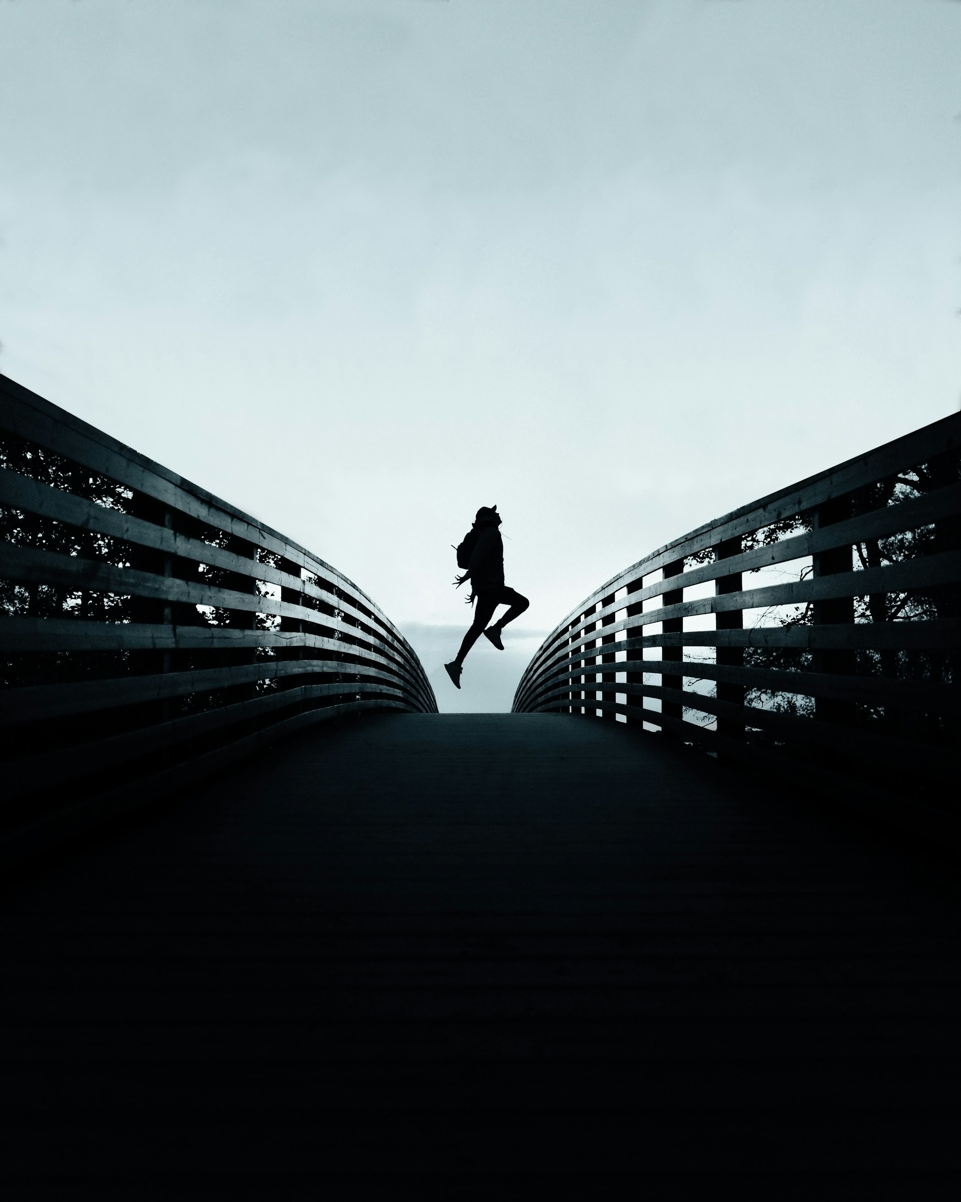 person jumping over the bridge