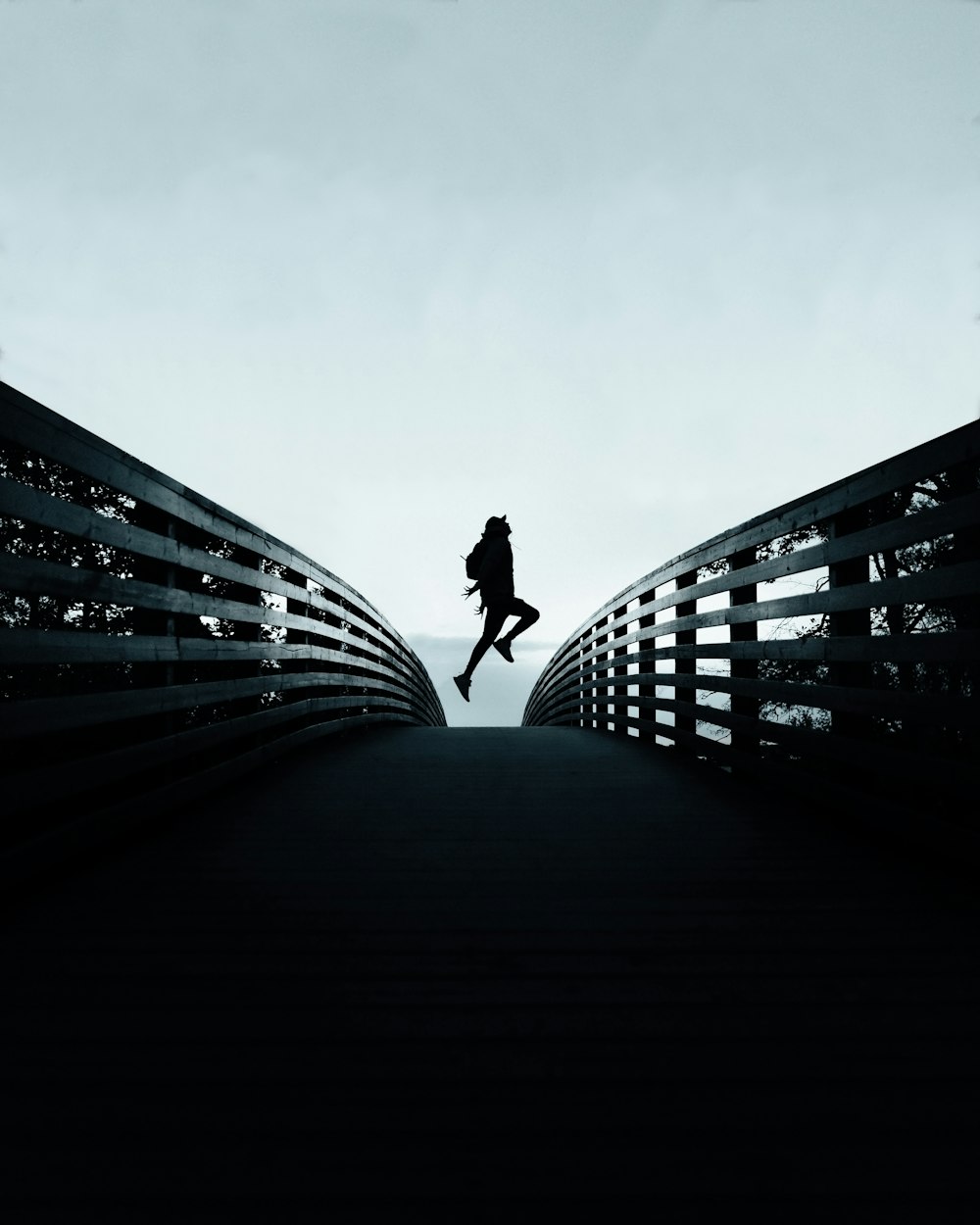 person jumping over the bridge