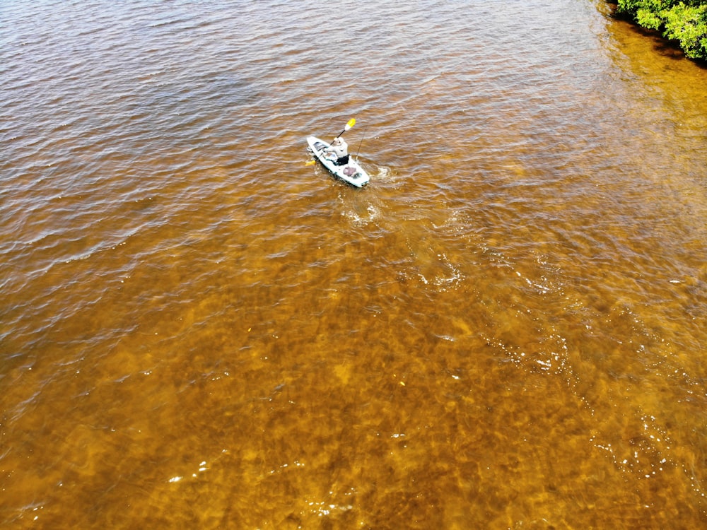 person kayaking on body of water