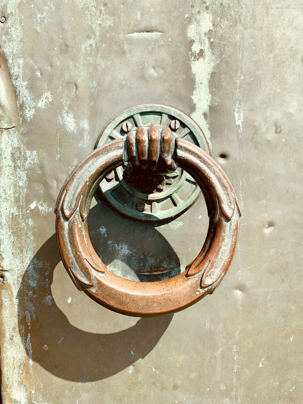 brown and green door knocker close-up photography