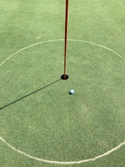 Close-up of a golf ball near the hole on the 4th green.