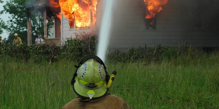 man near flaming house