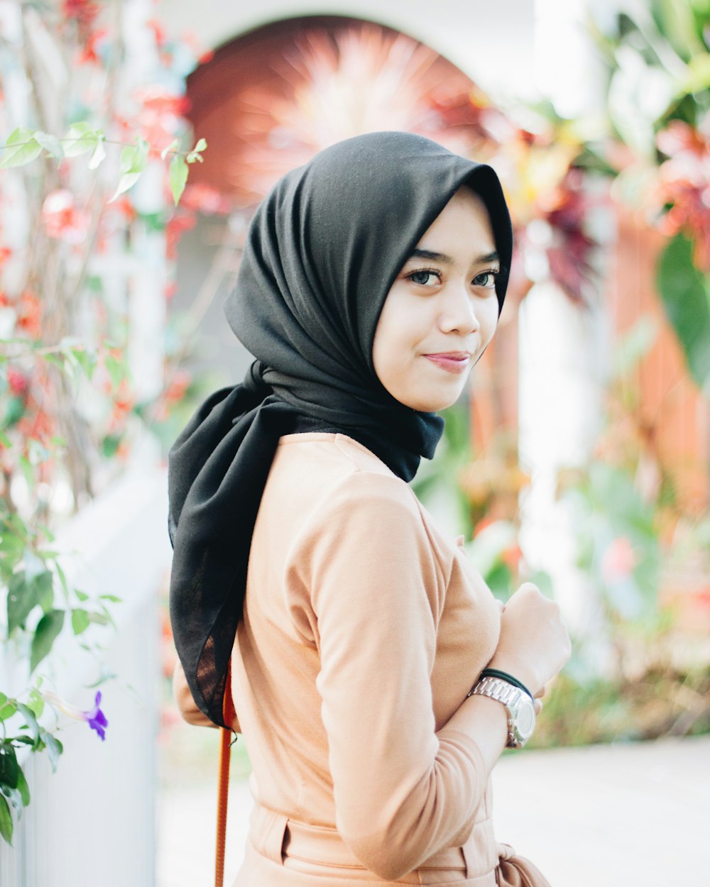 woman wearing beige abaya dress and black hijab headscarf