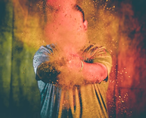 A wild-haired mad scientist laughing wildly as yellow lightning bolts crackle around him while dunking a green powder packet into a beaker mid-explosion.