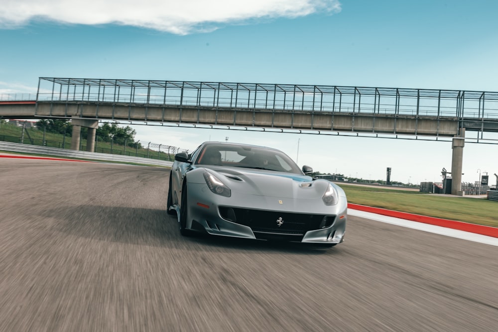 gray sports car across gray bridge