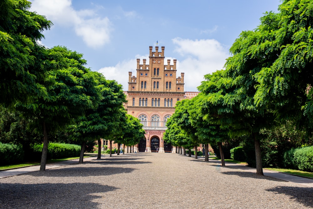 a large building surrounded by trees on a sunny day