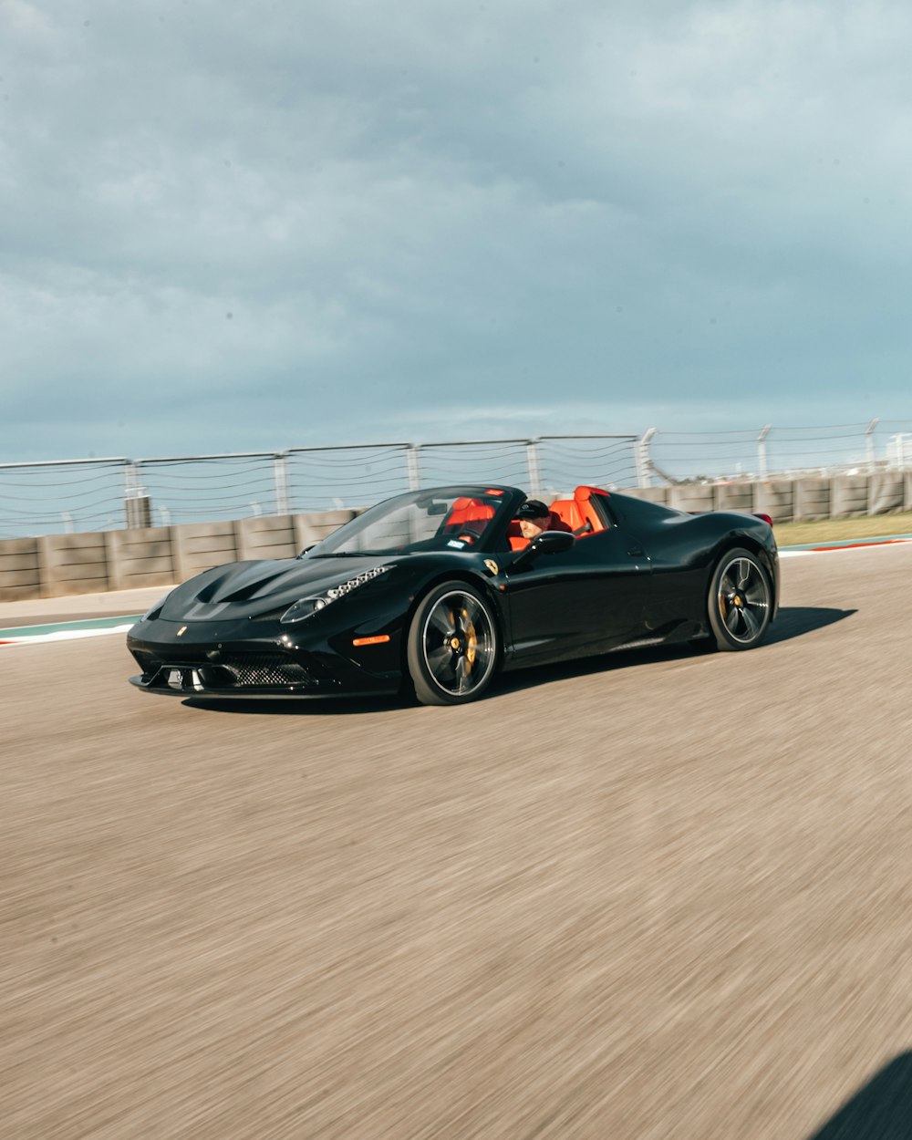 person riding sports coupe at daytime