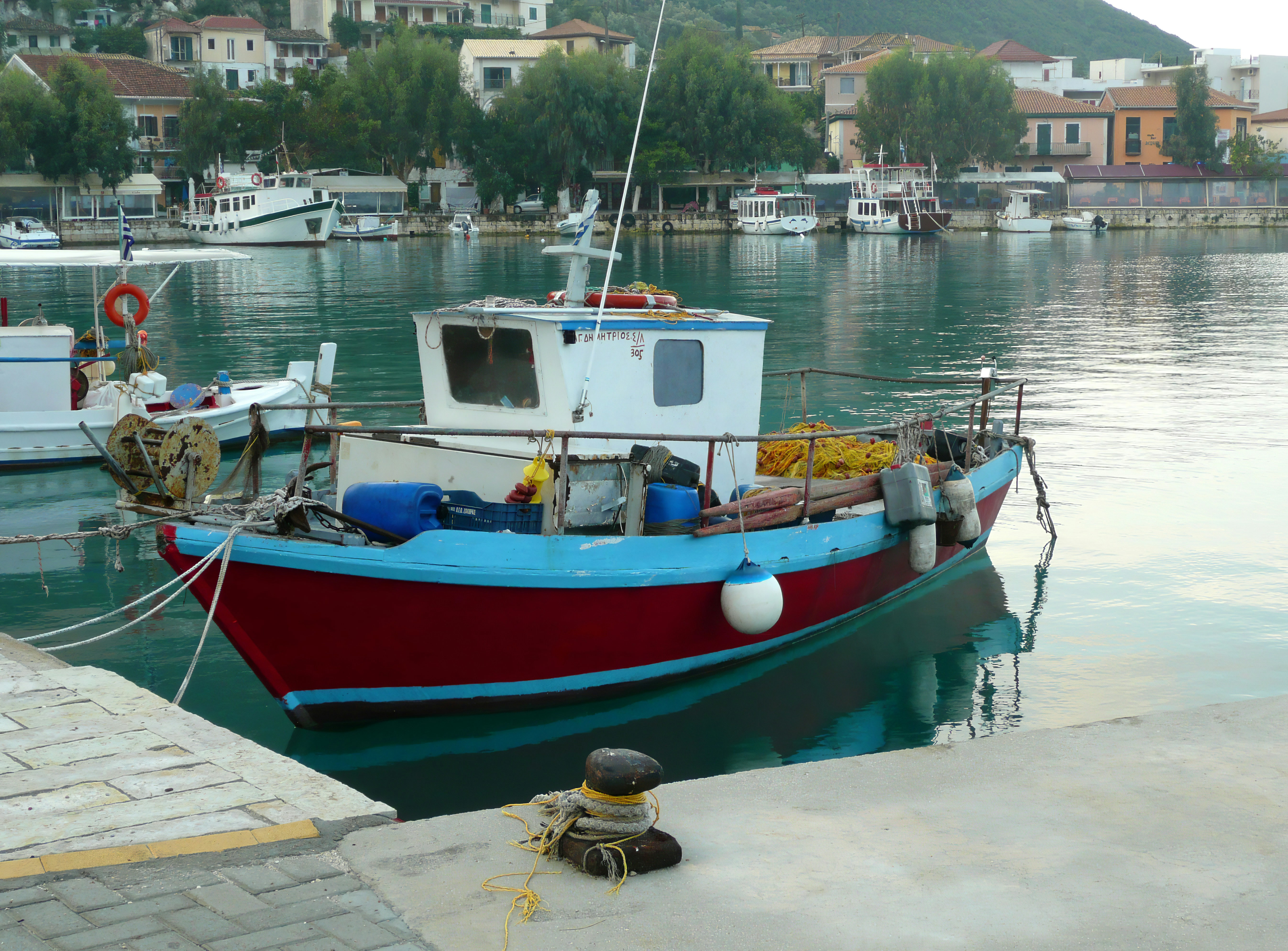 blue and red boat near dock