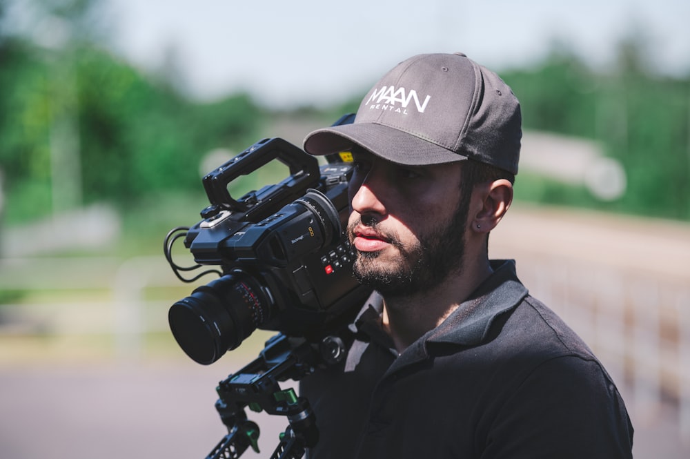 man with video camera on selective focus photography