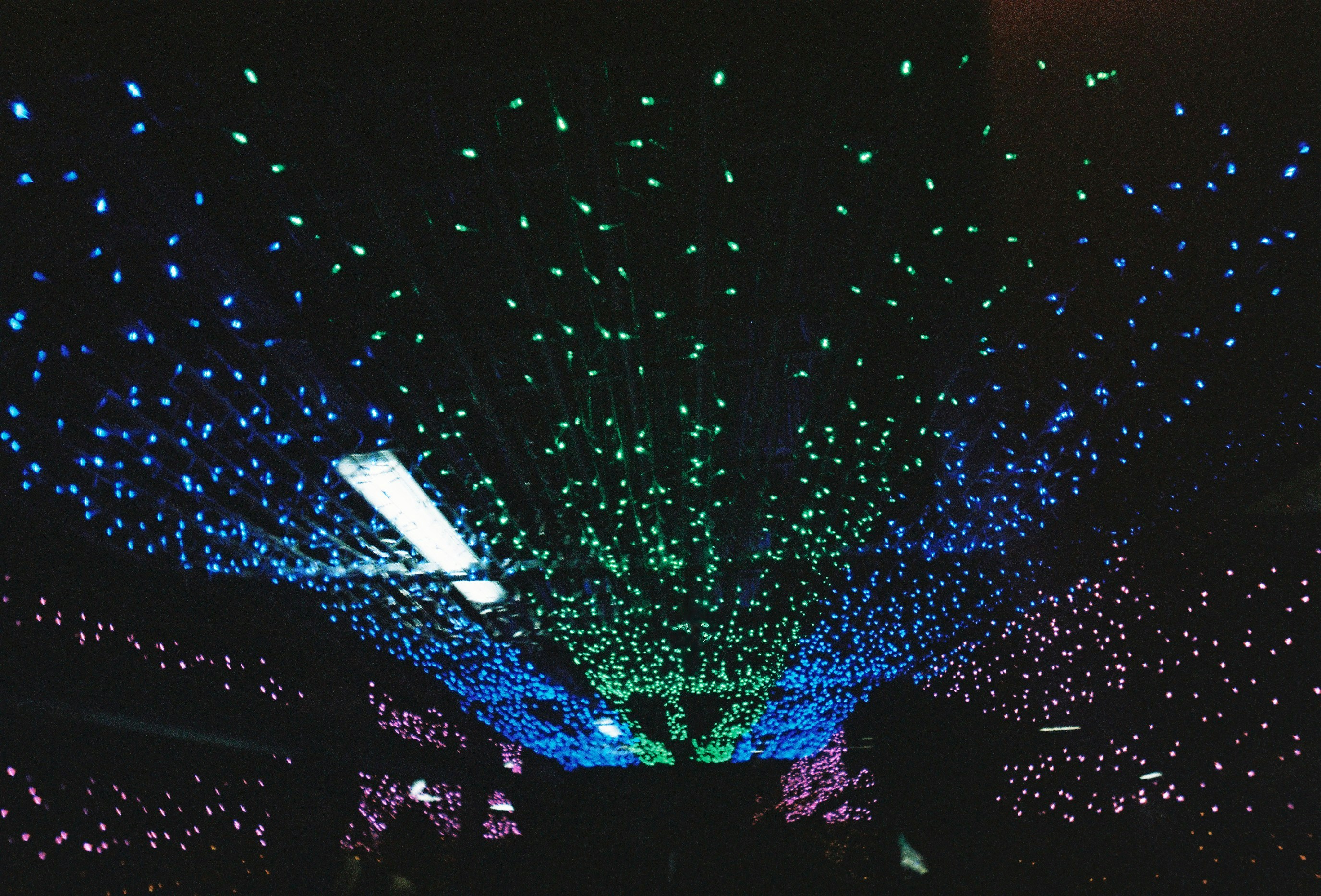 Coloured star lights across a dark ceiling