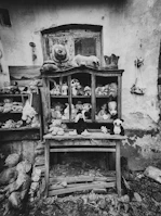 A playful scene with a variety of stuffed animals sitting on a vintage armchair.