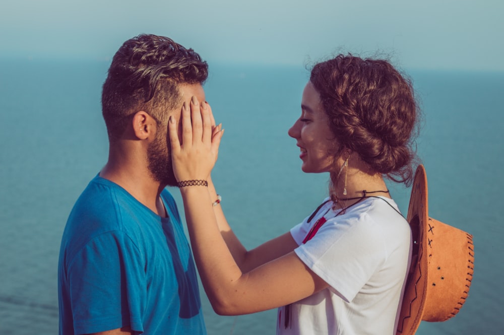 woman covering man's face what guys want in a long distance relatipnship
