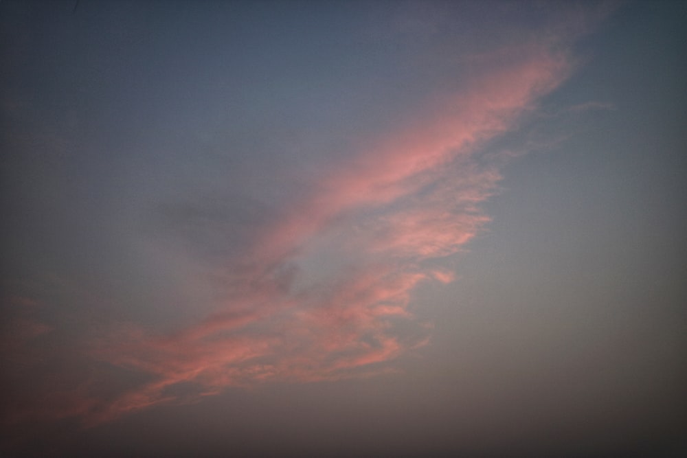 a kite flying in the sky at sunset