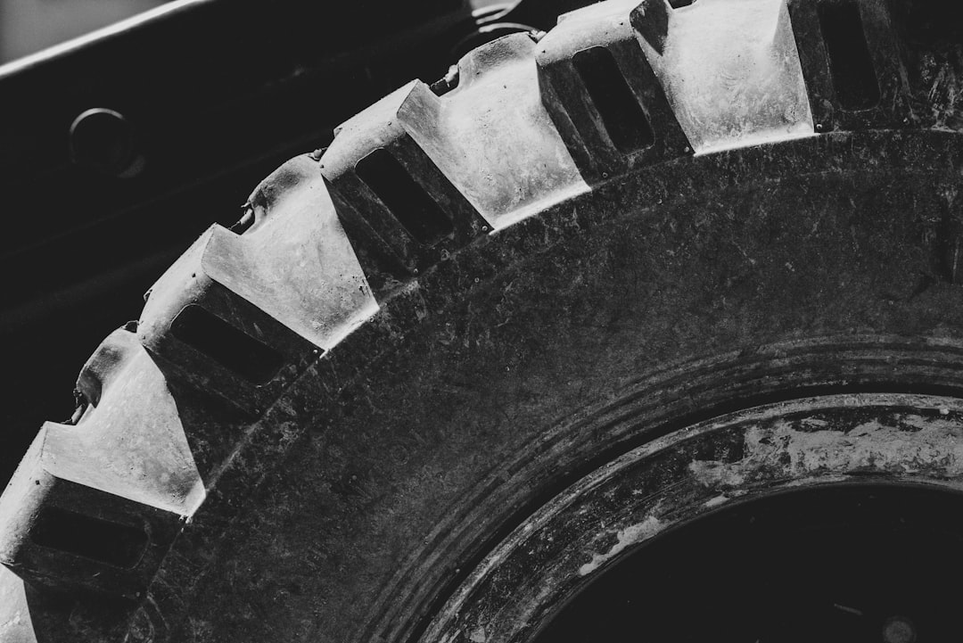 grayscale photo of truck wheel with tire