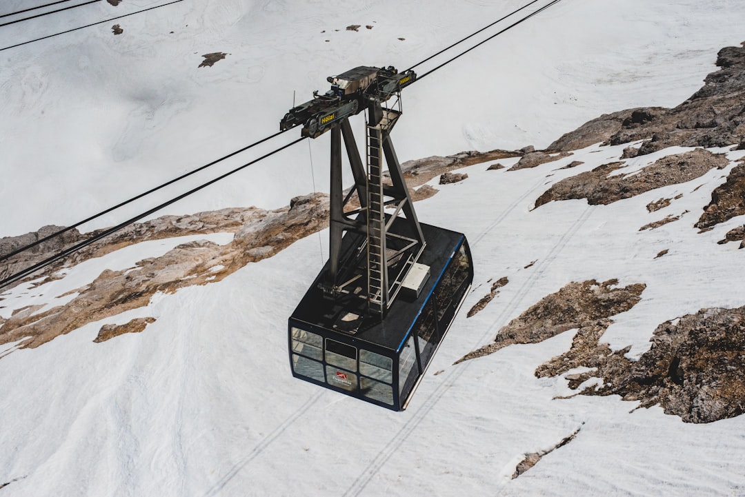 cable car passing snow mountain