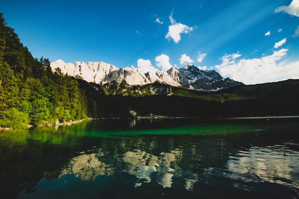 landscape photography of body of water near mountain