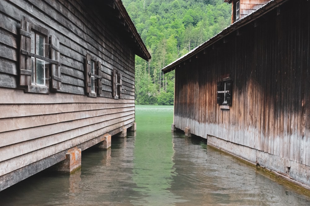 two brown wooden house on body of water