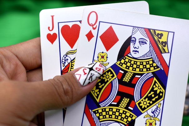 Close-up of a hand playing a winning card in an online rummy game on a tablet