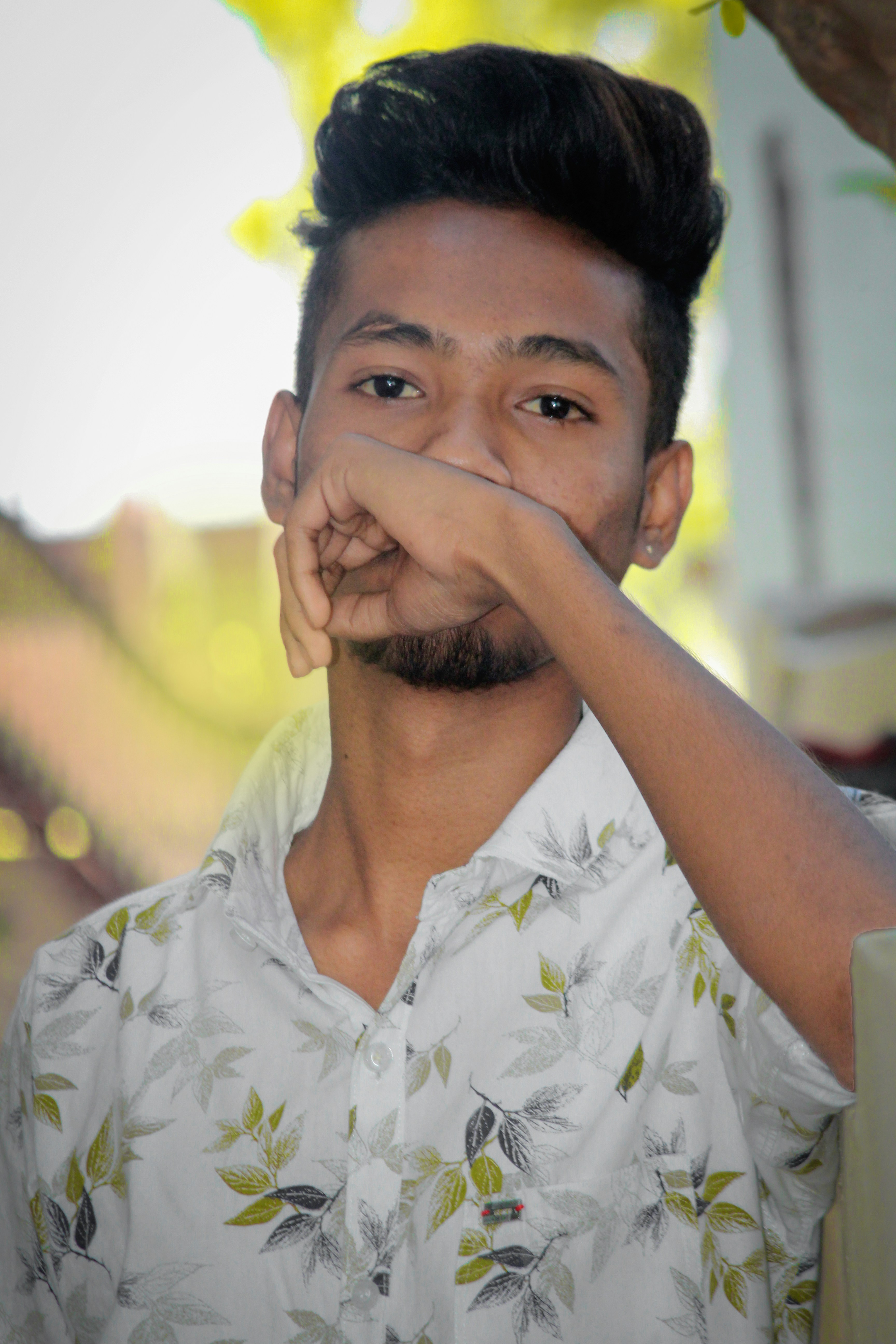 man in white and green floral dress shirt