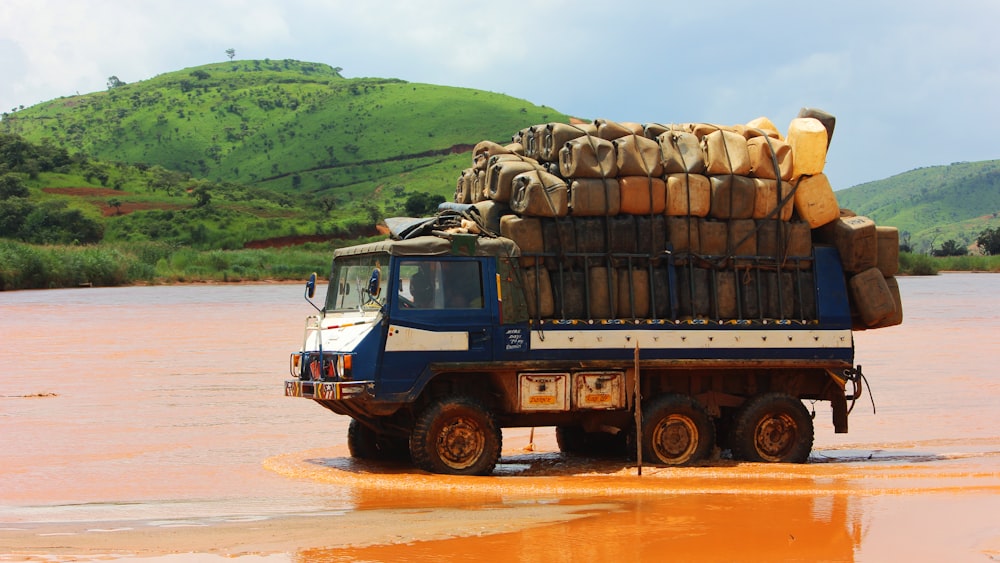 blue truck filled with container