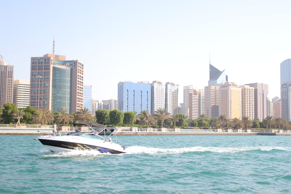 white and black powerboat in bay