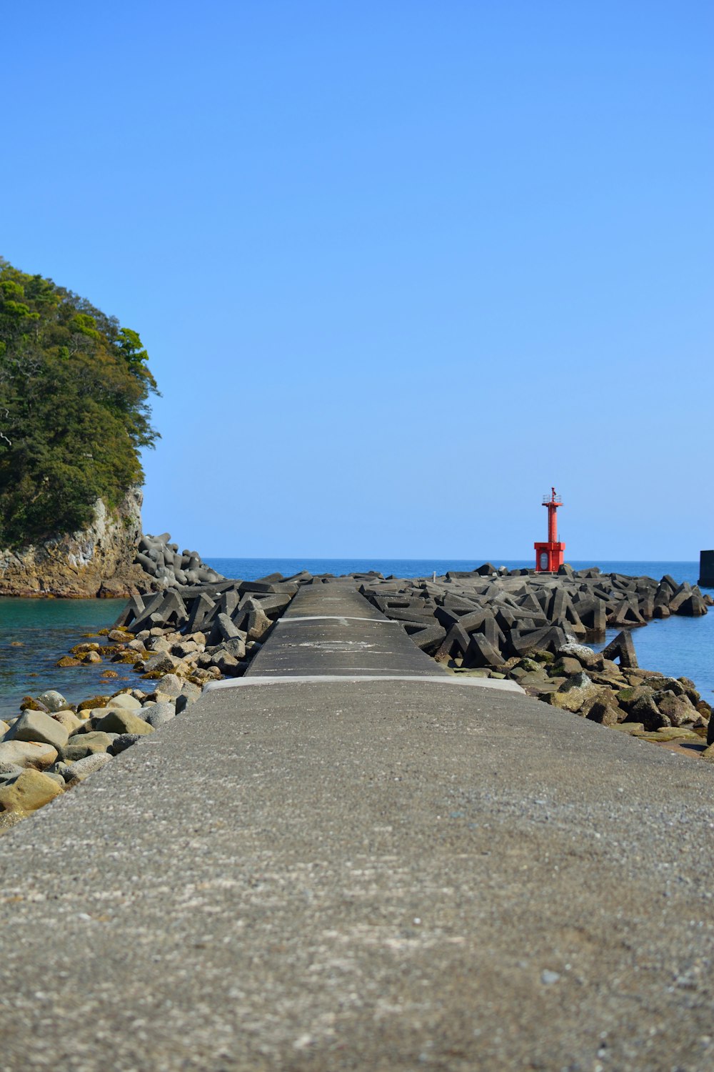 concrete dock beside body of water