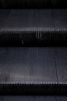 A close-up of an escalator's steps in motion.