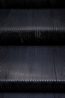A close-up of an escalator's steps in motion.