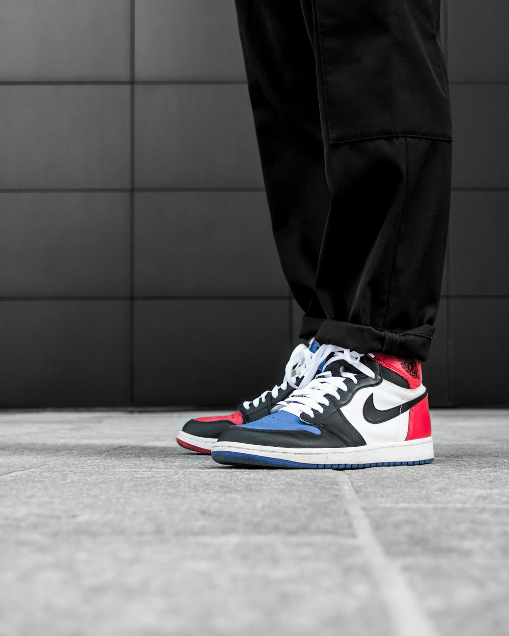 man wears blue-red-and-black Nike Air Jordan 1 shoes photo – Free Shoe Image on