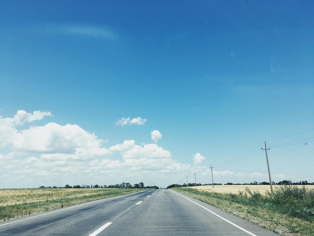 road between grass during daytime