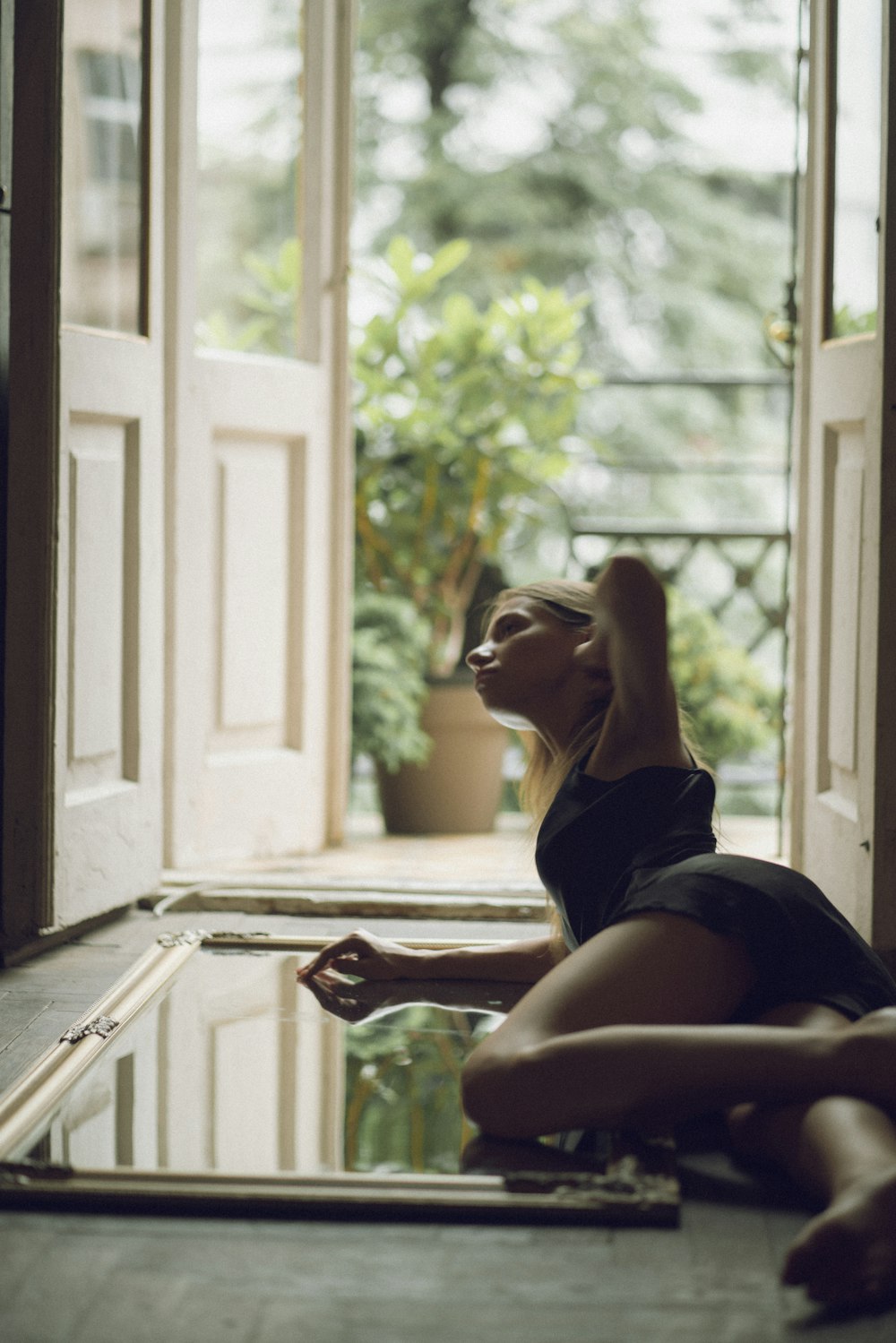 woman in black tank top lying on floor