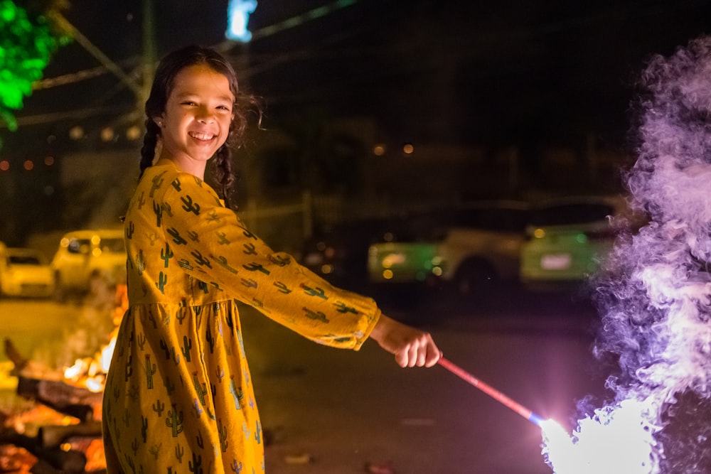 smiling girl holding sparkler