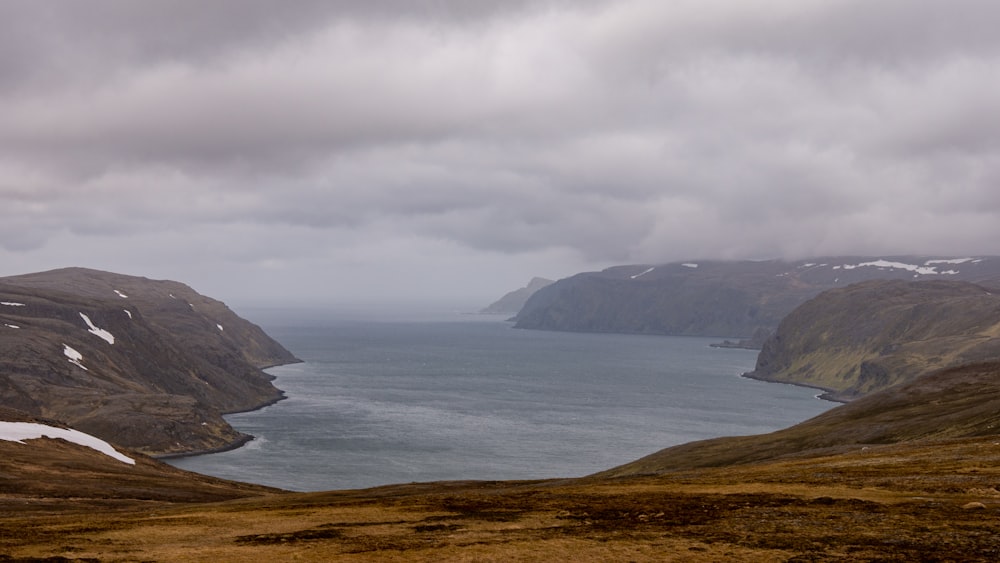 body of water under cloudy sky