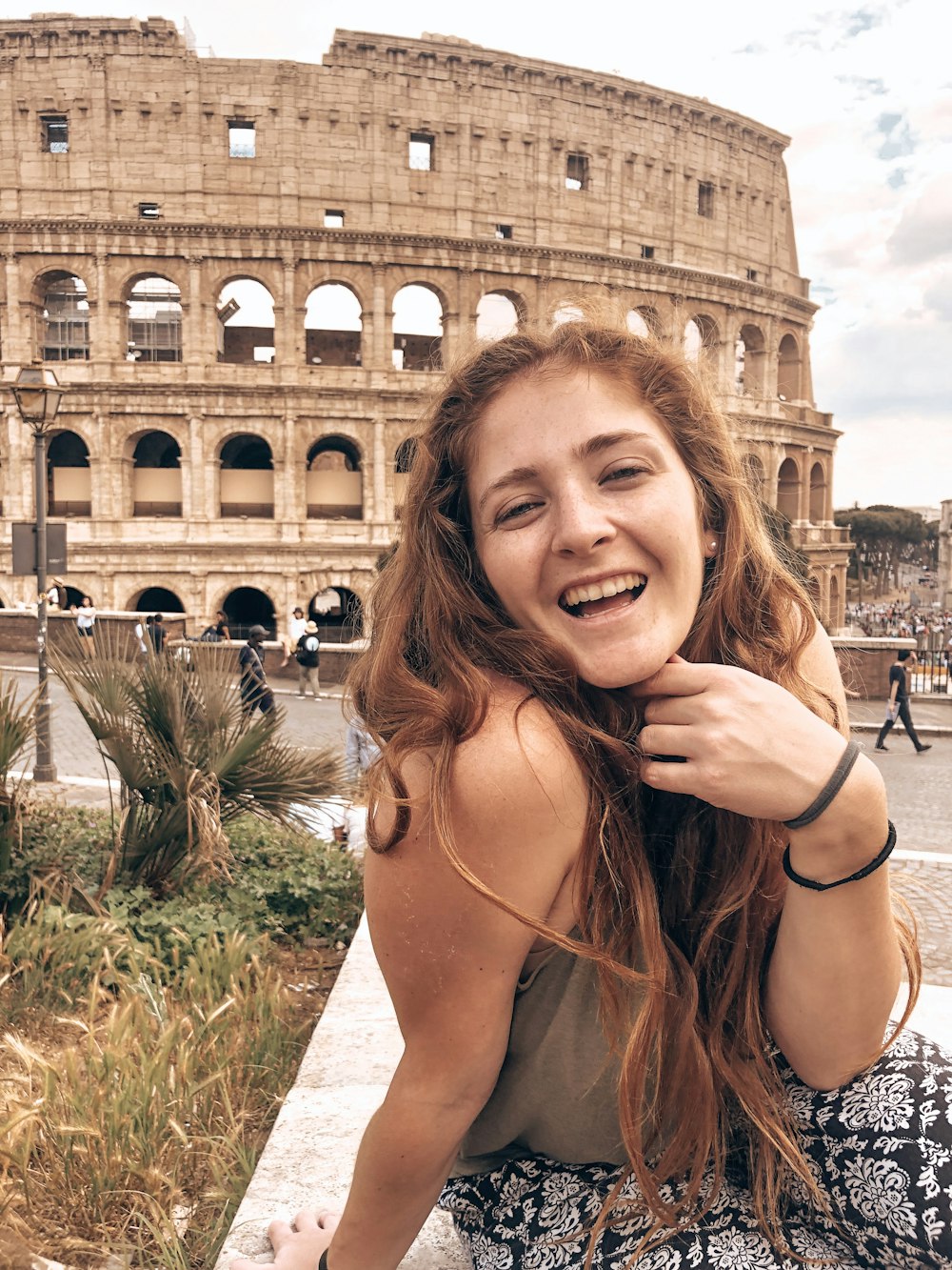 woman smiling near coliseum