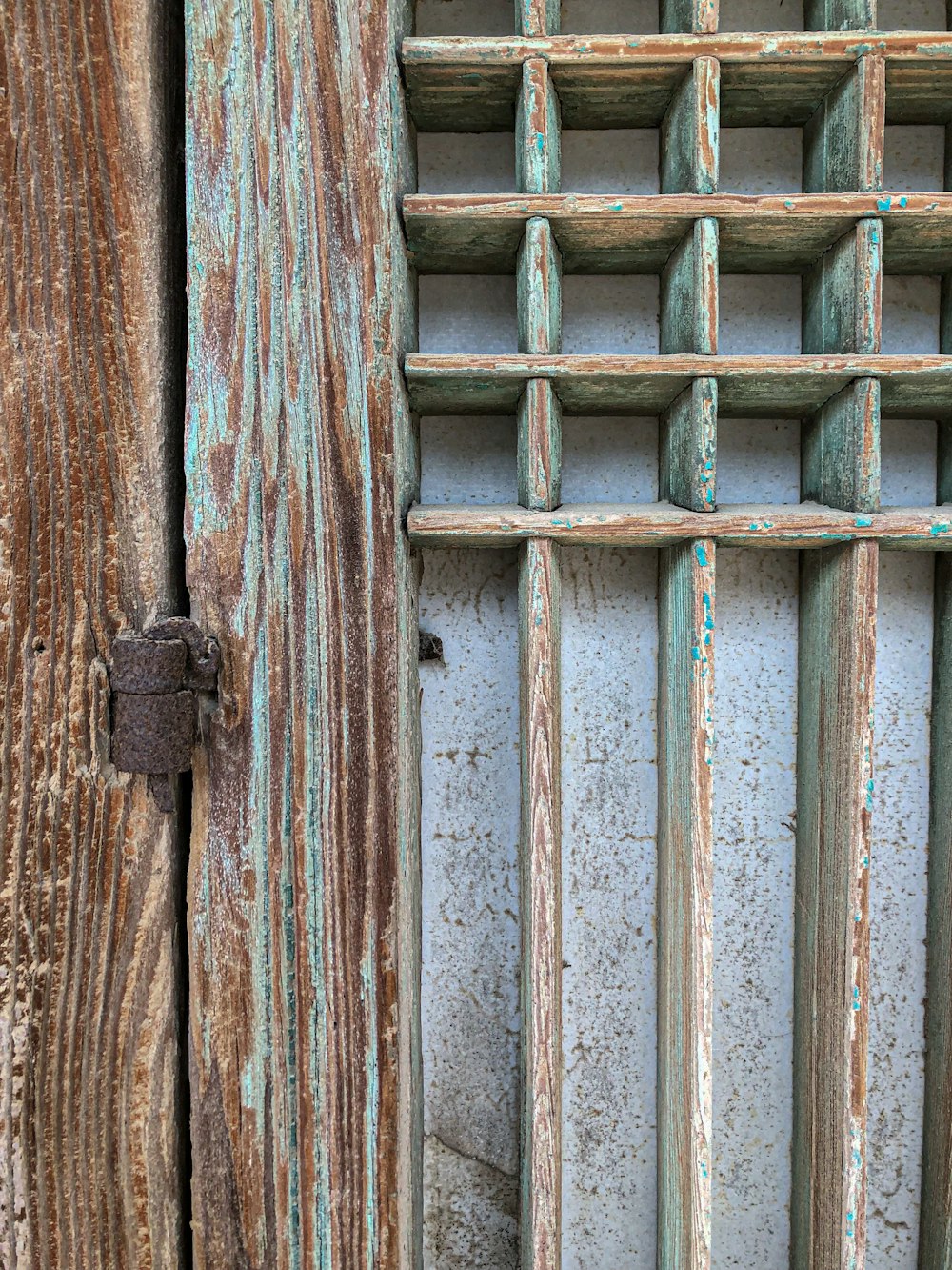 a close up of a wooden door with bars