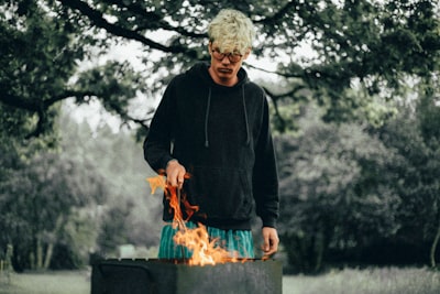 man standing in front of fire solstice teams background